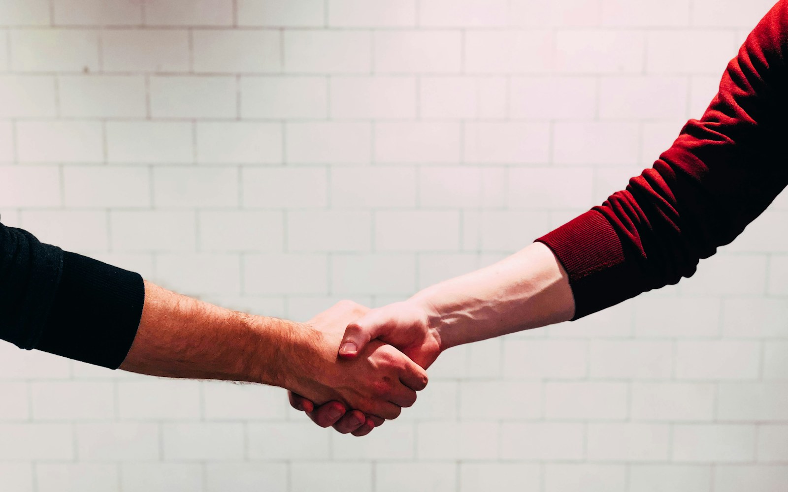 A homeowner shaking hands with a contractor